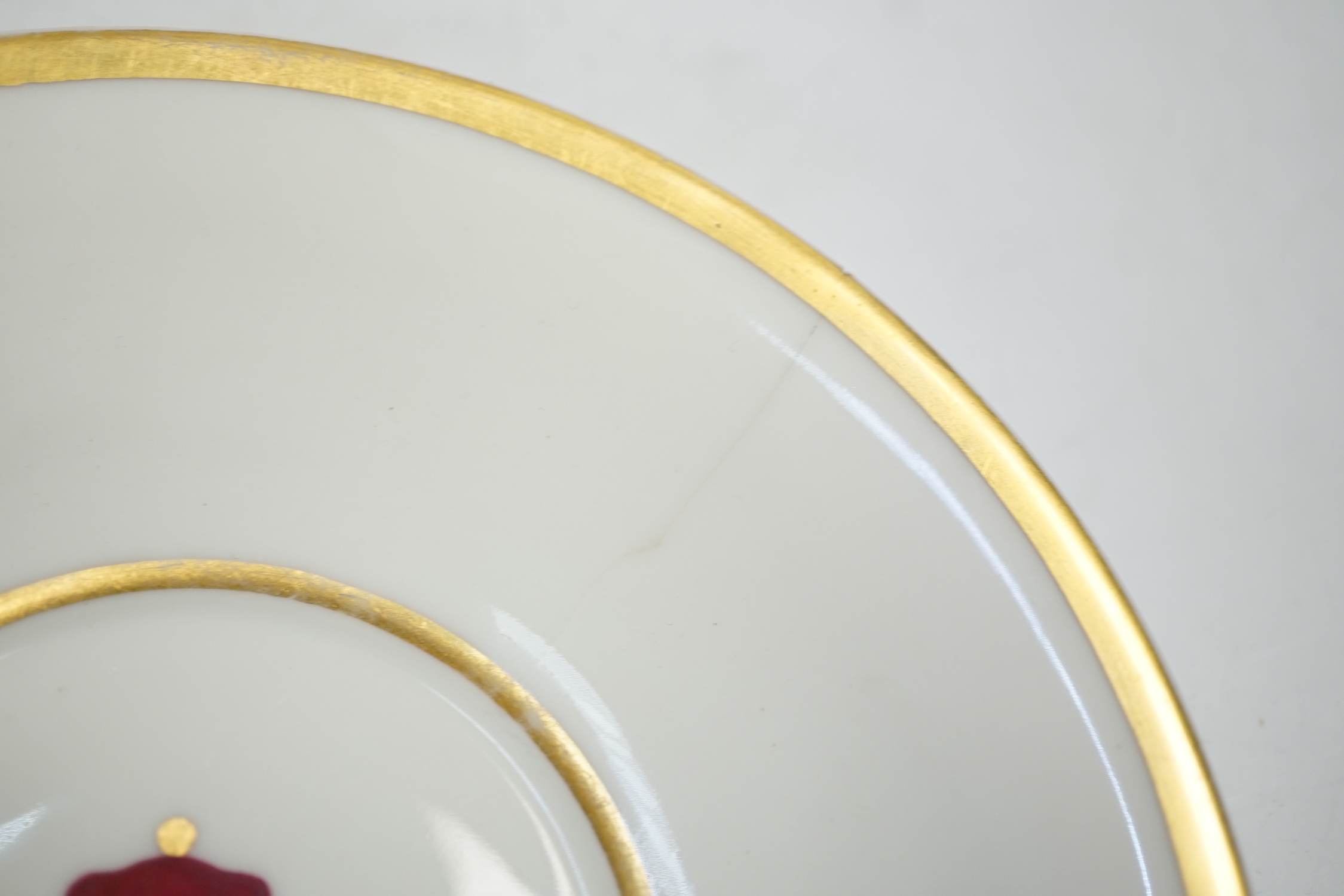A pair of German porcelain armorial cups and saucers, one saucer reads ‘Lord Bingham s/m Y. Powell. Born 1848’